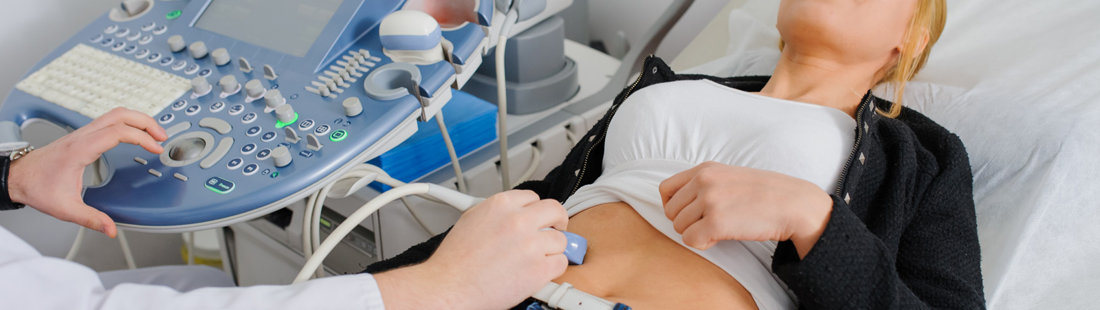 Doctor makes the patient women abdominal ultrasound